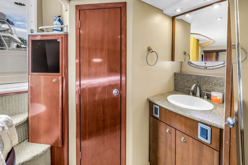 Slide: The Image of 2007 Meridian 459 Motoryacht bathroom with wooden cabinetry and granite countertop. - 32