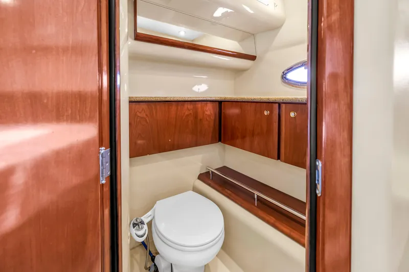 Slide: The Image of 2007 Meridian 459 Motoryacht bathroom with wooden cabinets and compact toilet. - 34