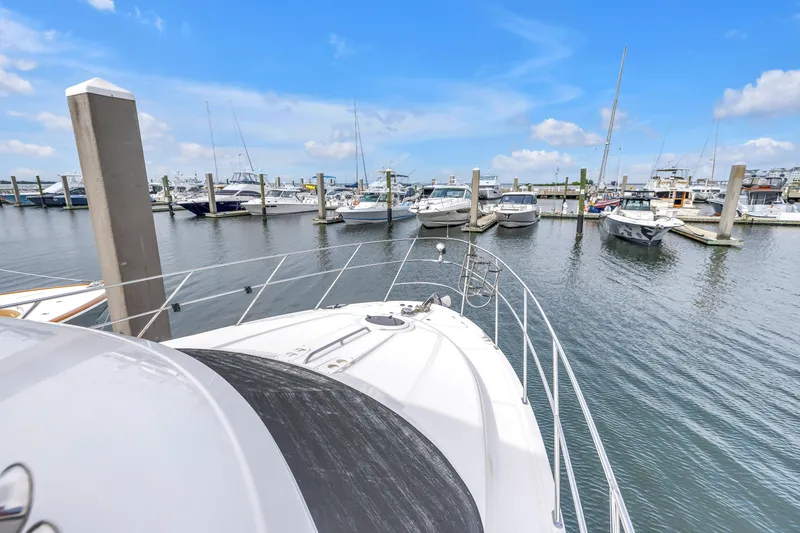 Slide: The Image of 2007 Meridian 459 Motoryacht docked in a marina with other boats under a clear blue sky. - 38