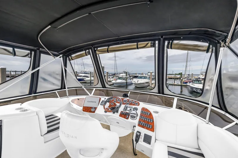Slide: The Image of 2007 Meridian 459 Motoryacht helm with marina view, featuring modern navigation equipment. - 40