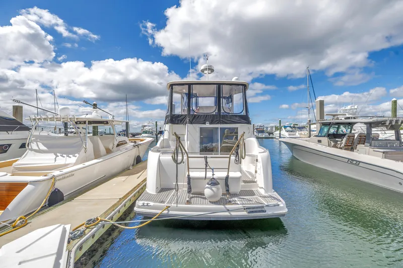 Slide: The Image of 2008 Meridian 459 Motoryacht docked at marina under blue sky and clouds. - 5