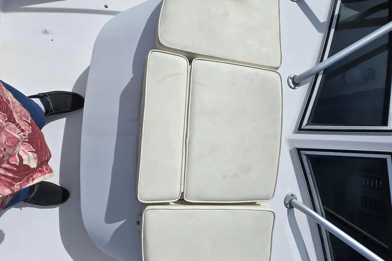 Slide: The Image of 1992 Grady-White Sailfish 25 Sportbridge deck with cushioned seating and metal railings. - 12