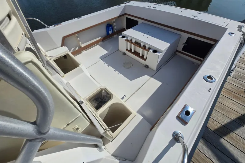 Slide: The Image of 1992 Grady-White Sailfish 25 Sportbridge boat interior with storage compartments and rod holders. - 15