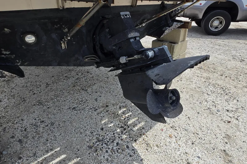 Slide: The Image of 1992 Grady-White Sailfish 25 Sportbridge outboard motor on gravel surface. - 24