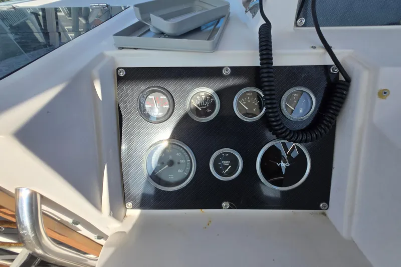 Slide: The Image of Dashboard of a 1992 Grady-White Sailfish 25 Sportbridge with gauges and controls. - 25