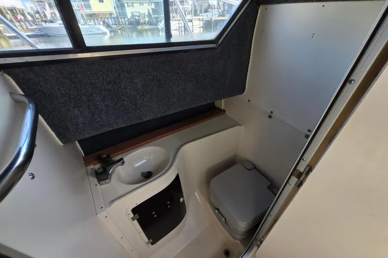 Slide: The Image of Interior of 1992 Grady-White Sailfish 25 Sportbridge boat with compact bathroom amenities. - 30