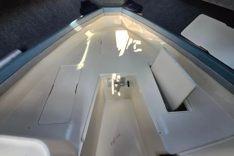 Slide: The Image of 1992 Grady-White Sailfish 25 Sportbridge interior with storage compartments and seating area. - 31