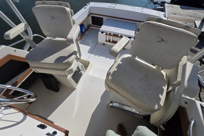 Slide: The Image of 1992 Grady-White Sailfish 25 Sportbridge boat interior with two swivel chairs. - 34