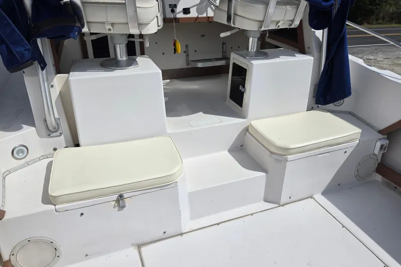 Slide: The Image of 1992 Grady-White Sailfish 25 Sportbridge interior with cushioned seating and storage compartments. - 6