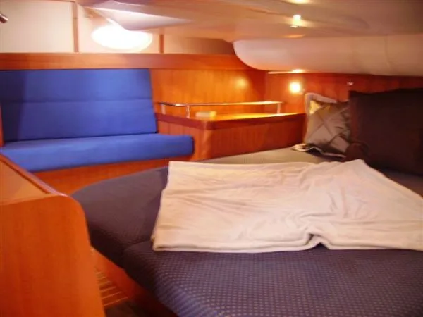 Slide: The Image of Cozy cabin interior of 2007 Elan Impression 434 yacht with blue seating and wooden accents. - 12