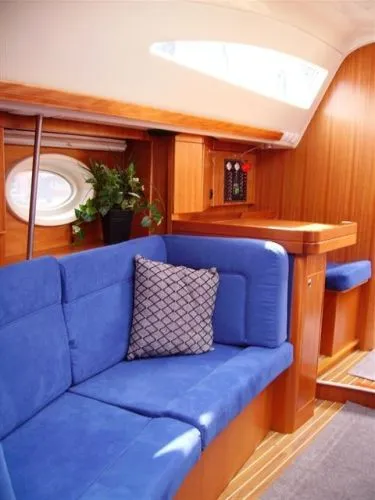 Slide: The Image of Interior of 2007 Elan Impression 434 yacht with blue seating and wooden accents. - 6
