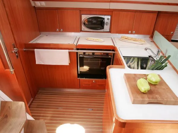 Slide: The Image of Luxurious 2007 Elan Impression 434 yacht kitchen with wood cabinetry and modern appliances. - 8