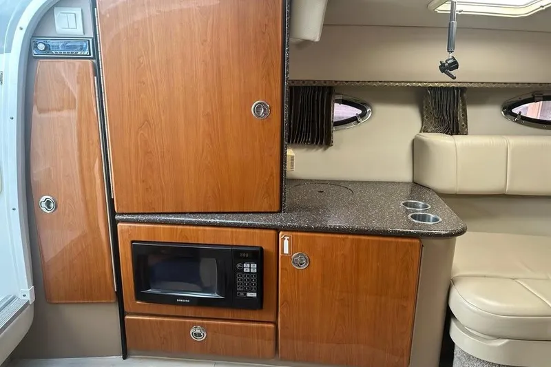 Slide: The Image of 2004 Formula 330 Sun Sport cabin interior with wood cabinetry and microwave. - 19