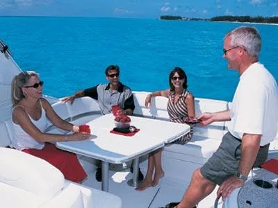 Slide: The Image of 2004 Formula 330 Sun Sport boat cruising near waterfront homes. - 2