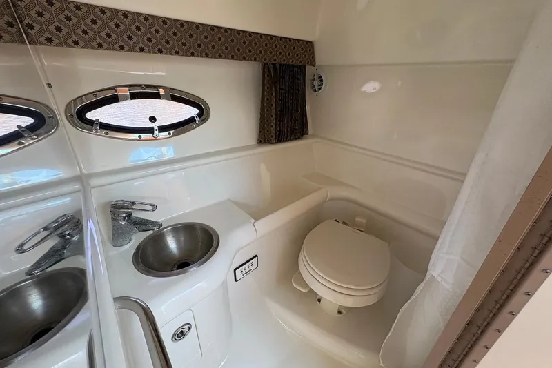 Slide: The Image of 2004 Formula 330 Sun Sport bathroom with sink, toilet, and porthole window. - 20