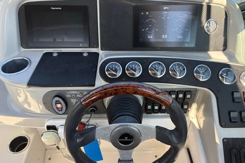 Slide: The Image of Dashboard of a 2004 Formula 330 Sun Sport boat with steering wheel and gauges. - 22