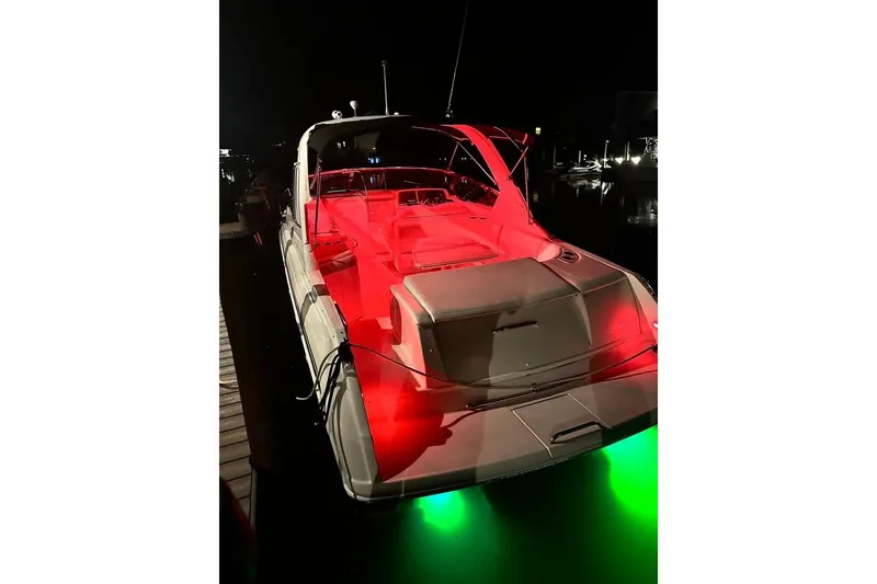 Slide: The Image of 2004 Formula 330 Sun Sport boat illuminated with red and green lights at night. - 27