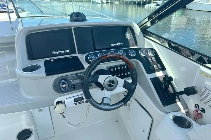 Slide: The Image of 2004 Formula 330 Sun Sport boat dashboard with Raymarine displays and steering wheel. - 8