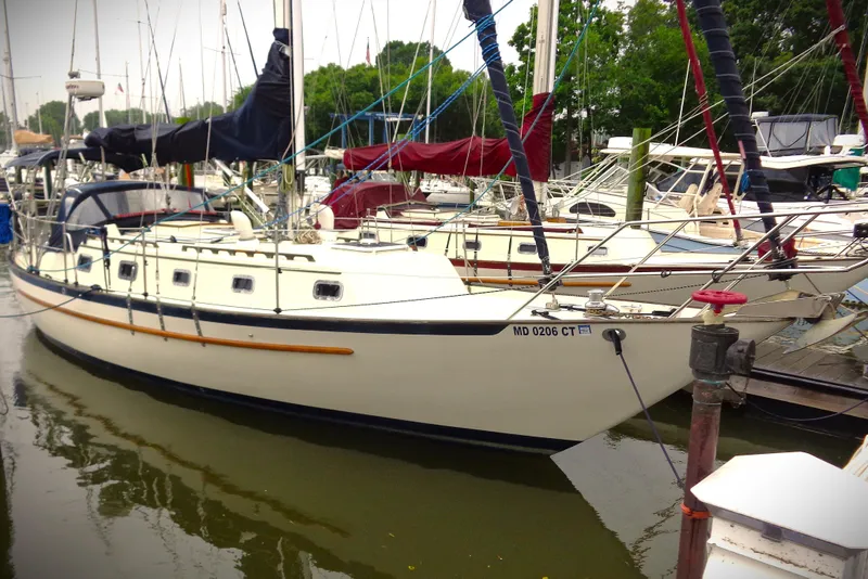 The Image of 1995 Pacific Seacraft 37 sailboat docked in a marina, surrounded by other boats. - 0