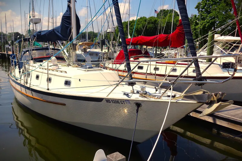 Slide: The Image of 1995 Pacific Seacraft 37 sailboat docked at a marina, surrounded by other boats. - 10