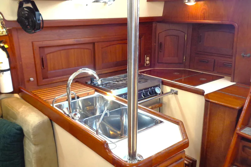 Slide: The Image of Interior of 1995 Pacific Seacraft 37 yacht kitchen with sink, stove, and wooden cabinetry. - 4