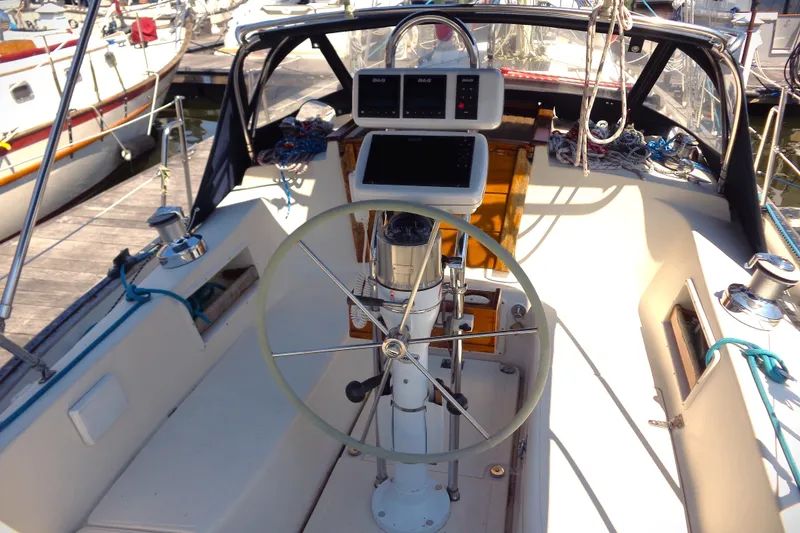 Slide: The Image of Cockpit of a 1995 Pacific Seacraft 37 sailboat with steering wheel and navigation equipment. - 7