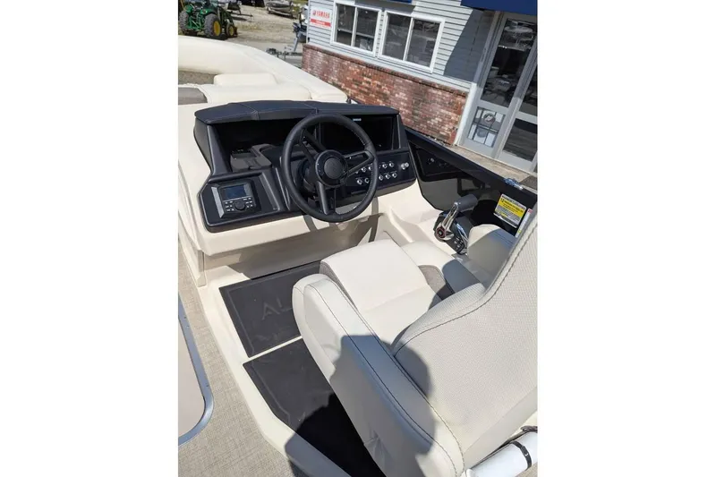 Slide: The Image of Interior of 2026 Alera M23L boat with steering wheel and control panel. - 12