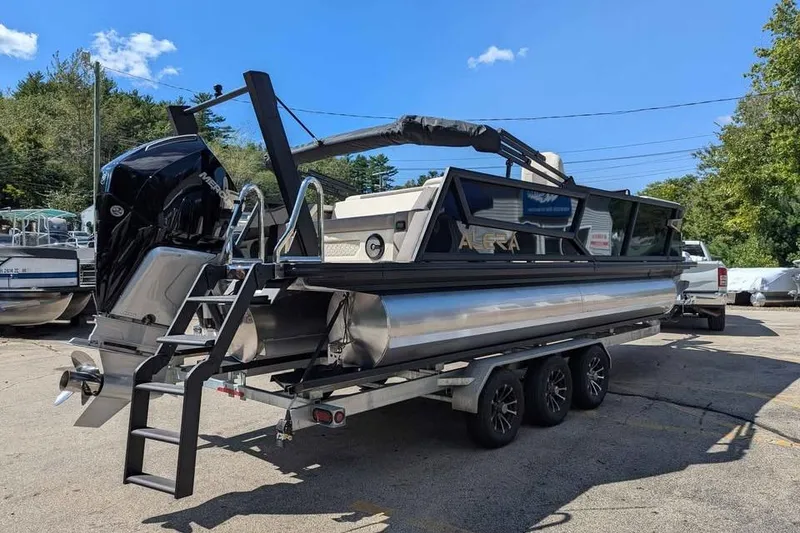 Slide: The Image of 2026 Alera M23L pontoon boat on trailer, featuring sleek design and powerful outboard motor. - 2