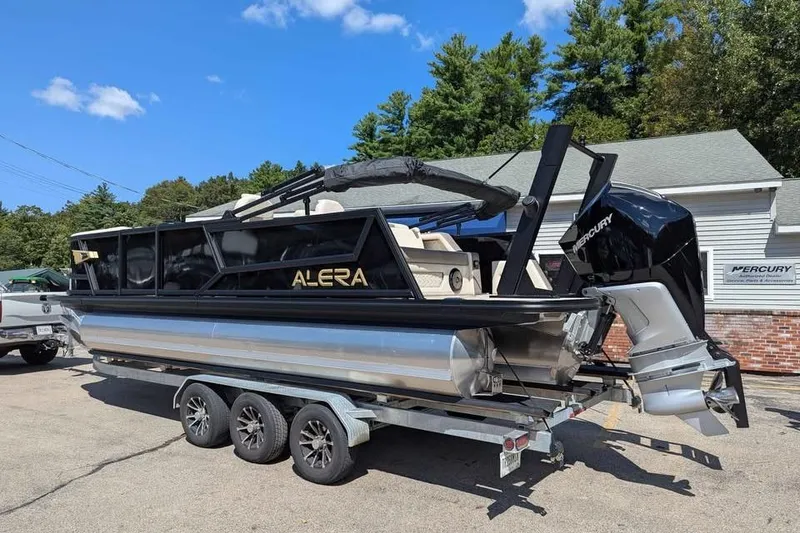 Slide: The Image of 2026 Alera M23L boat on trailer, featuring Mercury engine, parked outdoors. - 4
