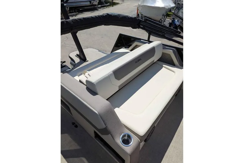 Slide: The Image of 2026 Alera M23L boat interior with beige seating and cup holder. - 8