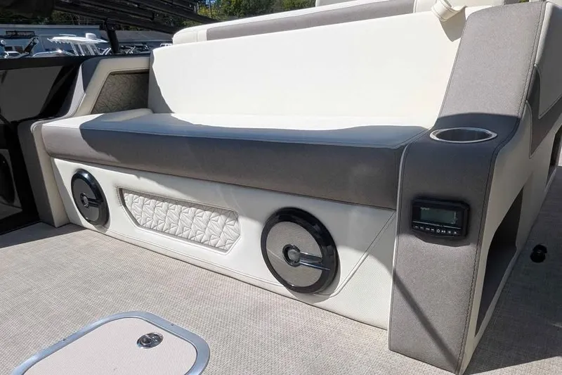 Slide: The Image of 2026 Alera M23L boat interior with cushioned seating, speakers, and control panel. - 9