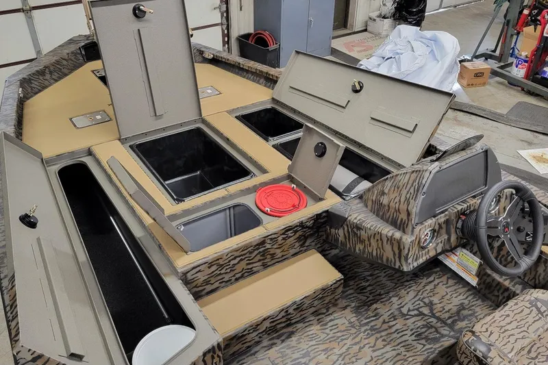 Slide: The Image of 2026 Xpress H20C Crappie boat interior with storage compartments and steering console. - 3