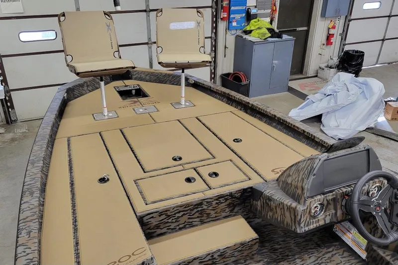 Slide: The Image of 2026 Xpress H20C Crappie boat interior with dual seats and camo design. - 5
