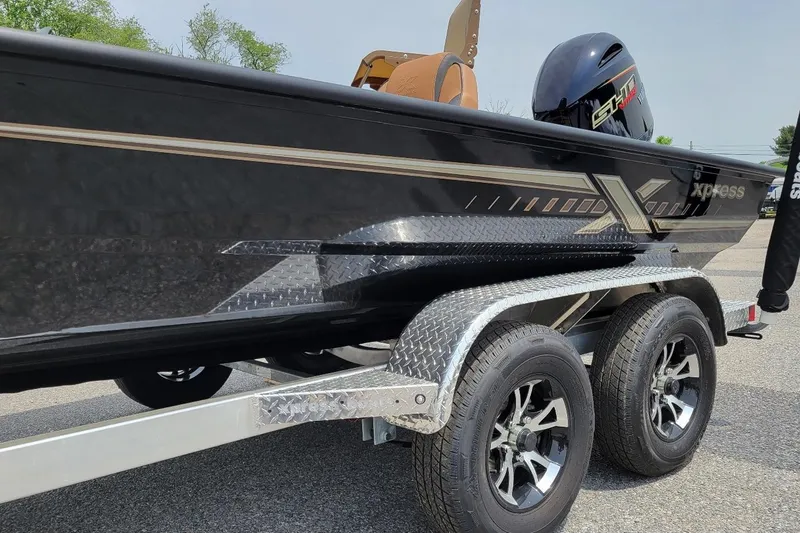 Slide: The Image of 2026 Xpress H20C Crappie boat on trailer, featuring sleek black design and dual wheels. - 3
