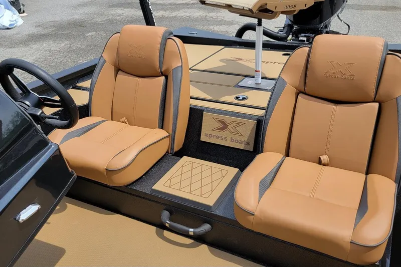 Slide: The Image of 2026 Xpress H20C Crappie boat interior with tan leather seats and steering wheel. - 6