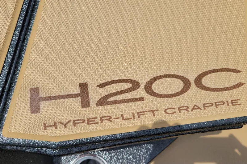 Slide: The Image of 2026 Xpress H20C Crappie boat with Hyper-Lift technology, beige textured surface. - 7
