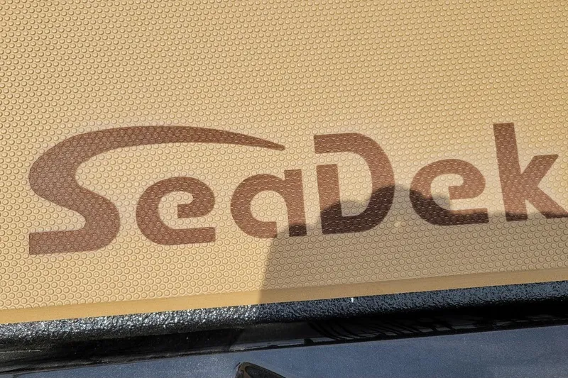 Slide: The Image of SeaDek logo on textured surface of 2026 Xpress H20C Crappie boat. - 8
