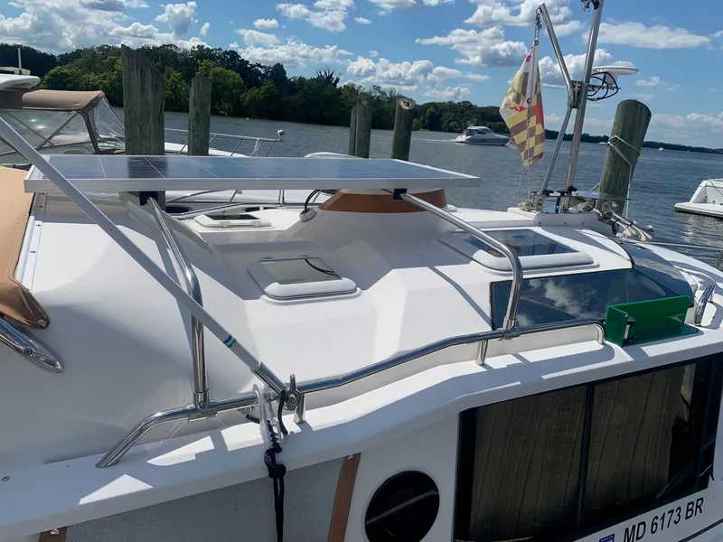 Slide: The Image of 2020 Ranger Tugs R-25 boat with solar panels docked by the water. - 10