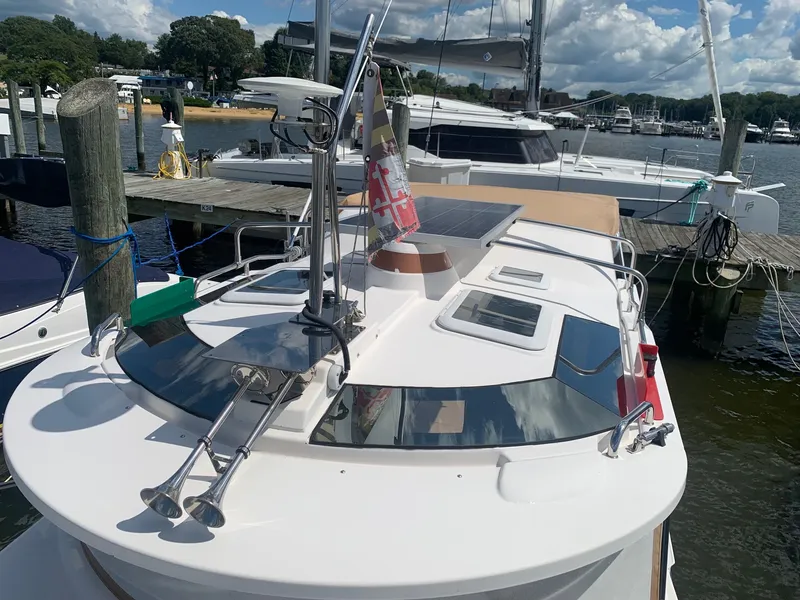 Slide: The Image of 2020 Ranger Tugs R-25 boat docked at marina, featuring solar panel and nautical equipment. - 12