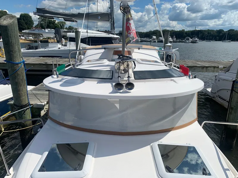 Slide: The Image of 2020 Ranger Tugs R-25 boat docked at marina under a partly cloudy sky. - 16