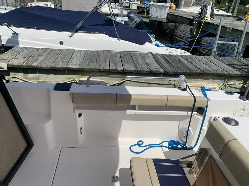 Slide: The Image of 2020 Ranger Tugs R-25 boat interior with seating and dock view. - 23