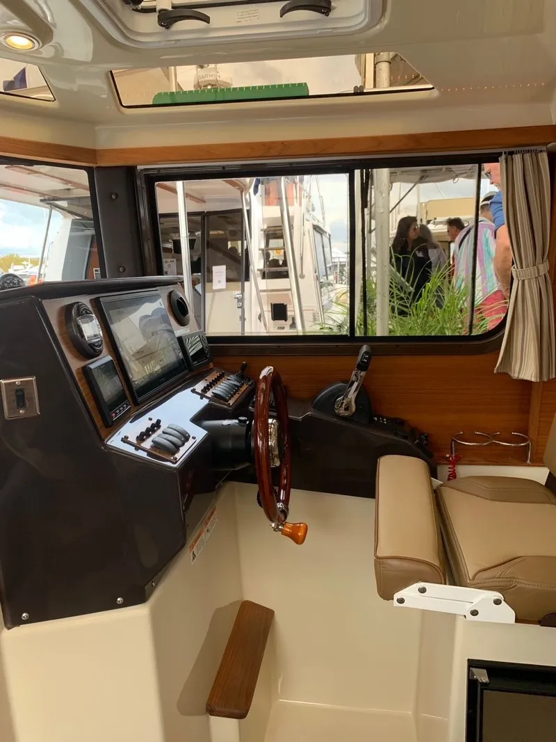 Slide: The Image of 2020 Ranger Tugs R-25 interior helm with modern controls and seating. - 28