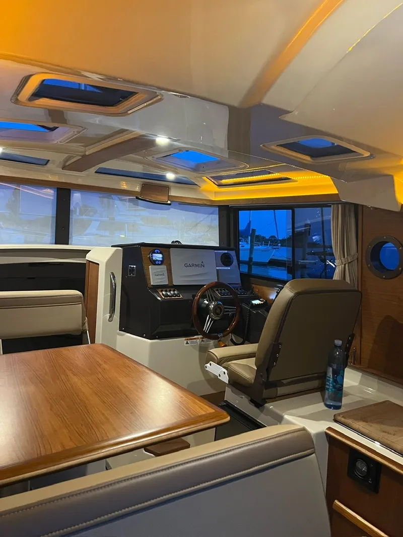 Slide: The Image of Interior of 2020 Ranger Tugs R-25 boat with modern helm and seating area. - 33