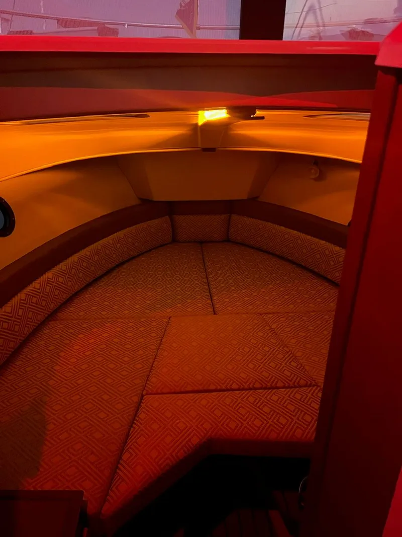 Slide: The Image of Cozy interior cabin of 2020 Ranger Tugs R-25 with warm lighting and cushioned seating. - 34