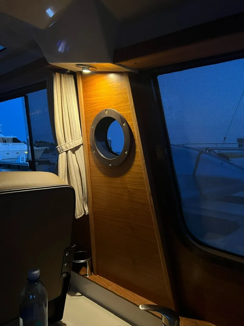 Slide: The Image of Interior of 2020 Ranger Tugs R-25 boat with porthole and ambient lighting. - 35