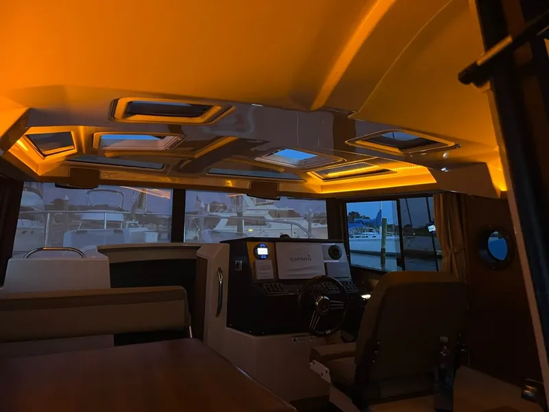 Slide: The Image of Interior of 2020 Ranger Tugs R-25 boat with ambient lighting and navigation equipment. - 36