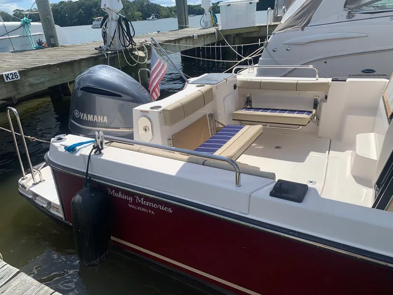 Slide: The Image of 2020 Ranger Tugs R-25 boat docked, featuring Yamaha engine and American flag. - 6