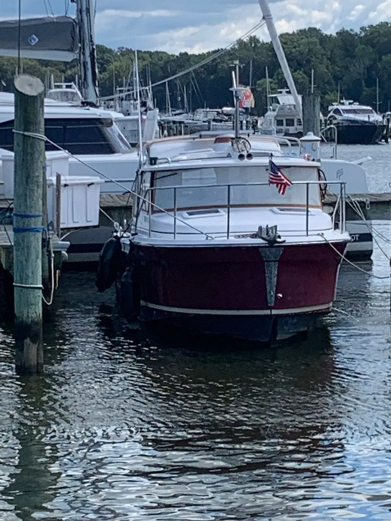 Slide: The Image of 2020 Ranger Tugs R-25 docked at a marina with American flag. - 8