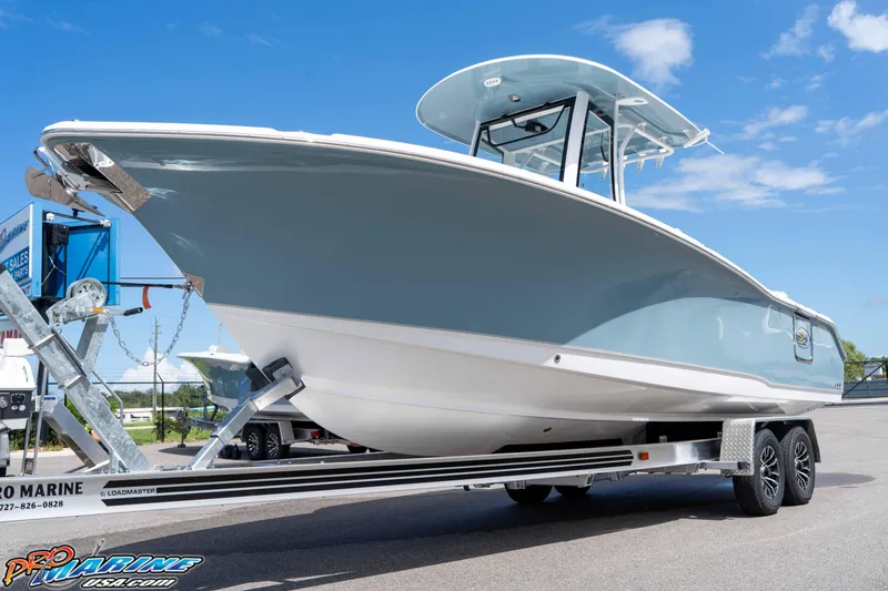 The Image of 2026 Sea Hunt Ultra 265 SE boat on trailer under clear blue sky. - 0
