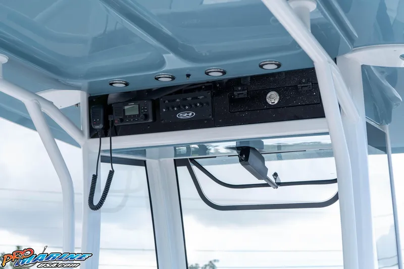 Slide: The Image of 2026 Sea Hunt Ultra 265 SE boat console with electronics and storage compartments. - 10